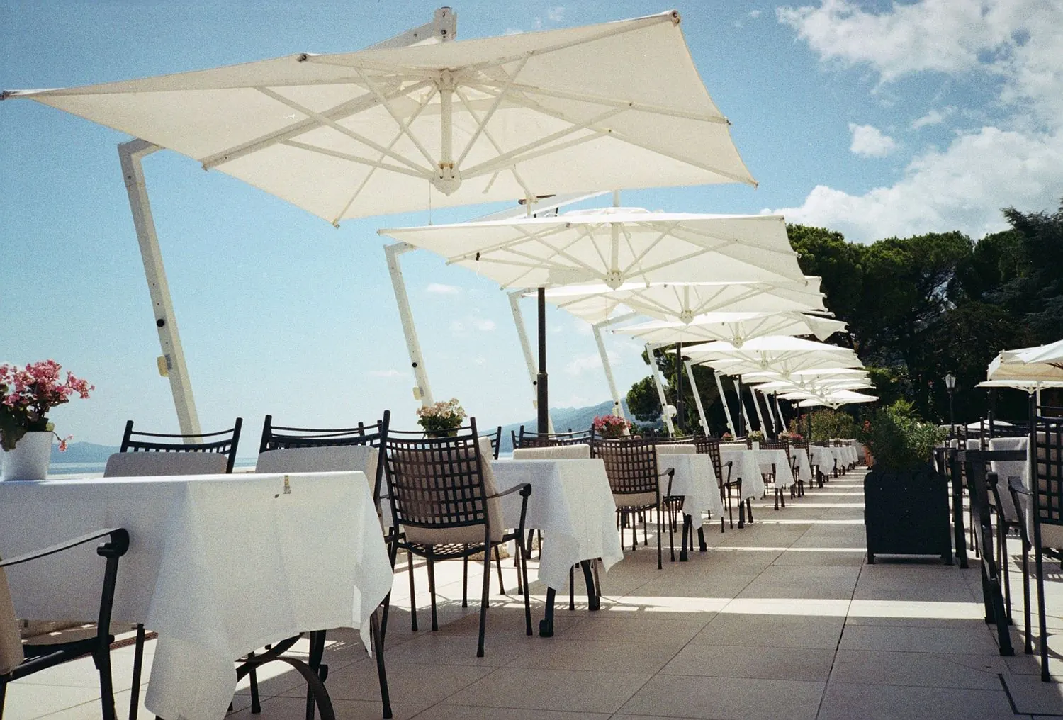 Terrasse ensoleillée aux parasols blancs